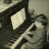 At the piano aged 8